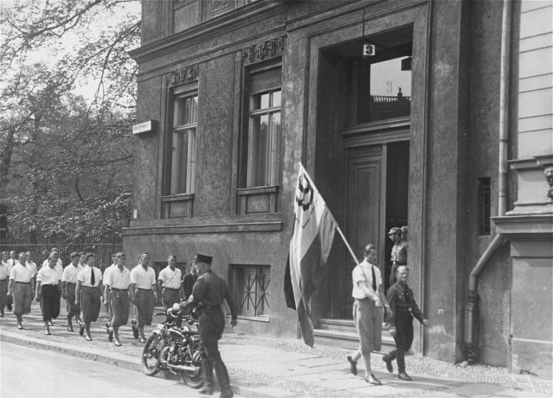 Rowes of German students parade in front of the Institute for Sexual Research building.