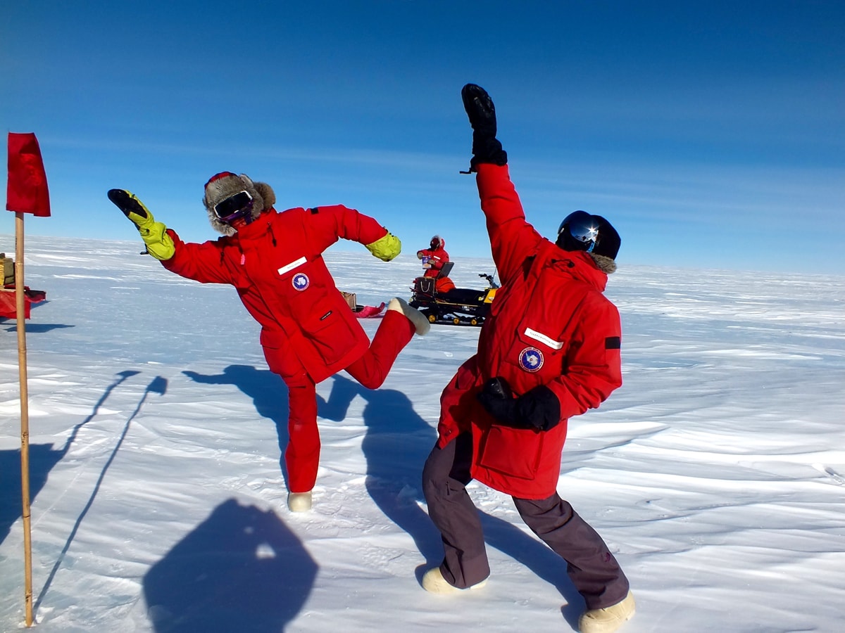 two scientists posing in full snow gear